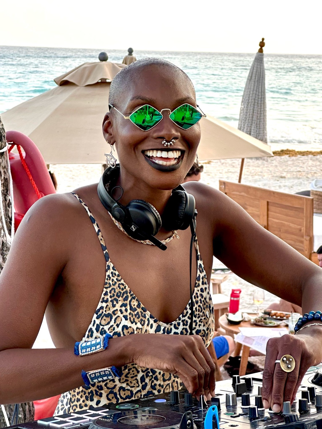 Aset of Kemet smiling at the decks by the sea, A Deia at the Beach